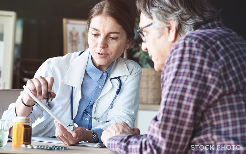 A doctor going over test results with a patient.